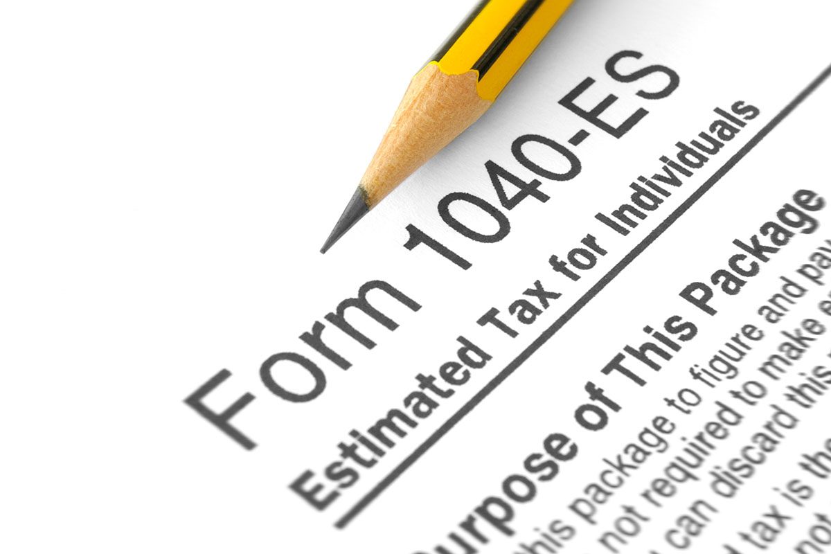 A sharpened yellow pencil rests on a Form 1040-ES, which is used to estimate tax payments for individuals.
