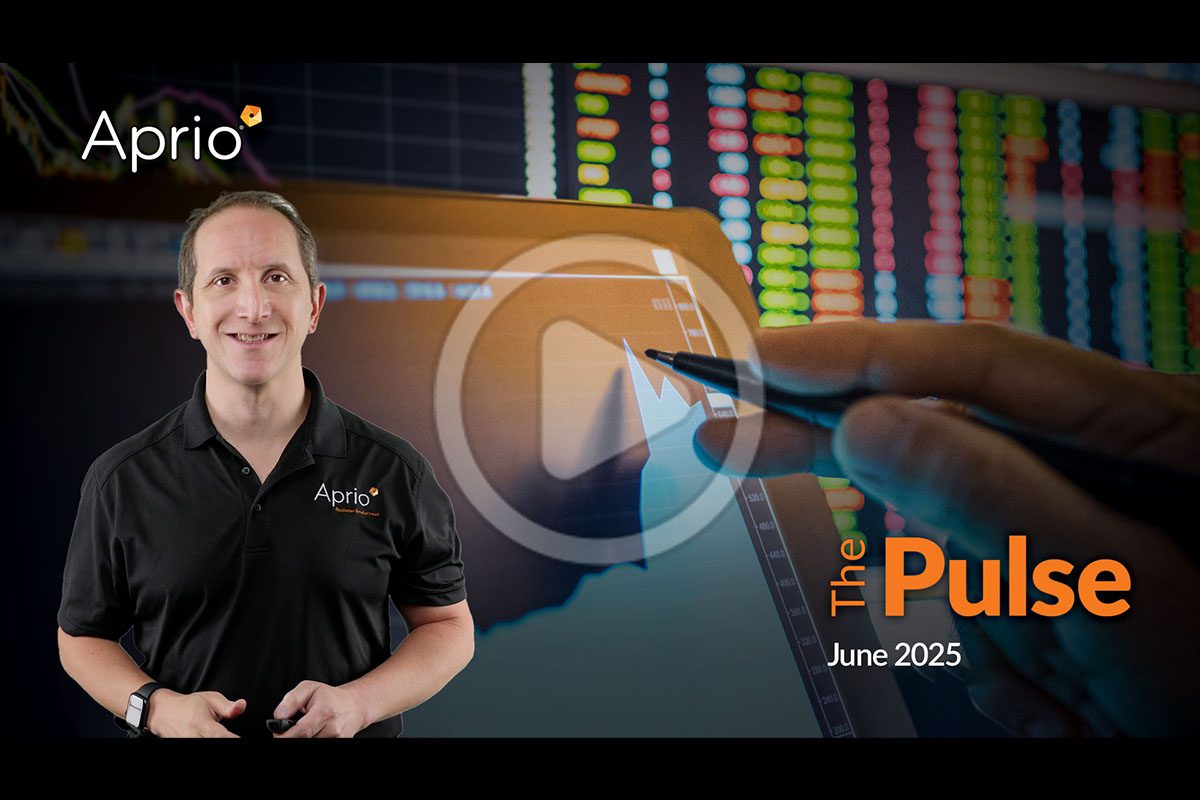 A man in an Aprio shirt stands in front of a digital screen showing financial graphs, with the text The Pulse June 2025 displayed.